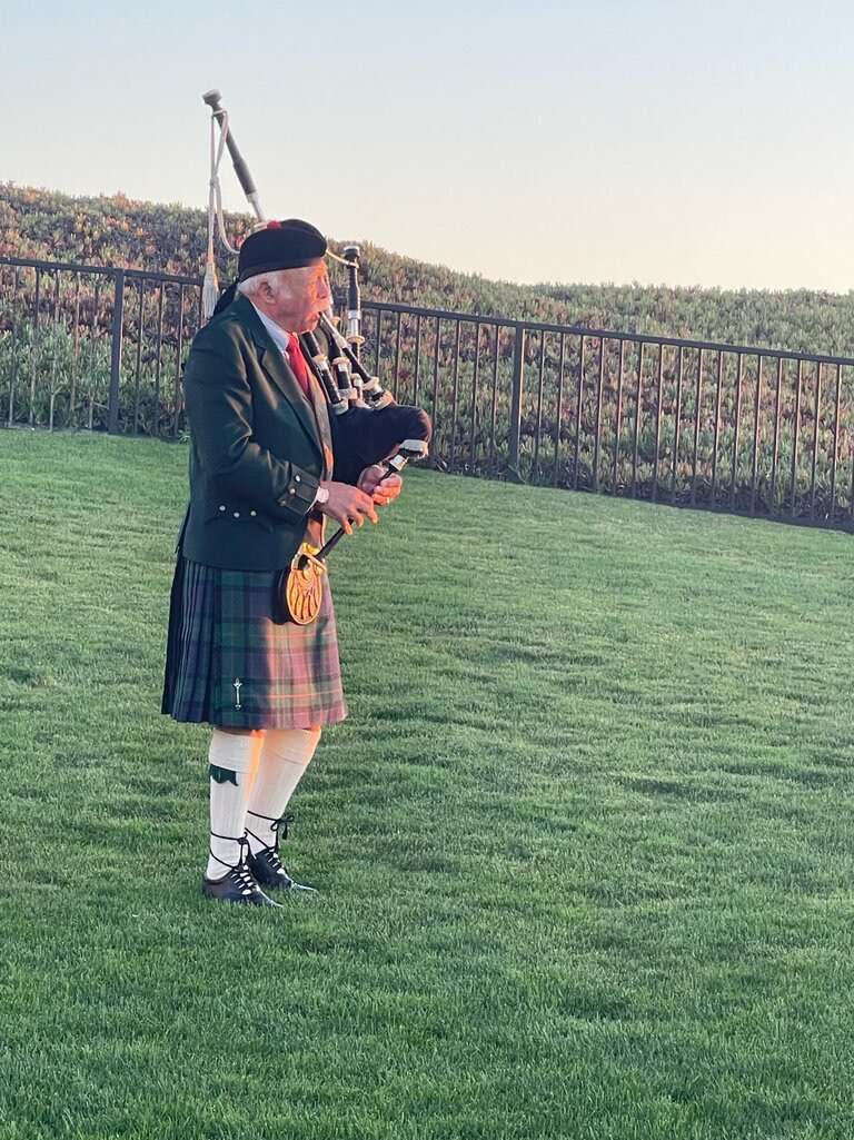 best couples golf trips: Bag pipers in field